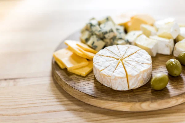 Various cheese types and olives — Stock Photo