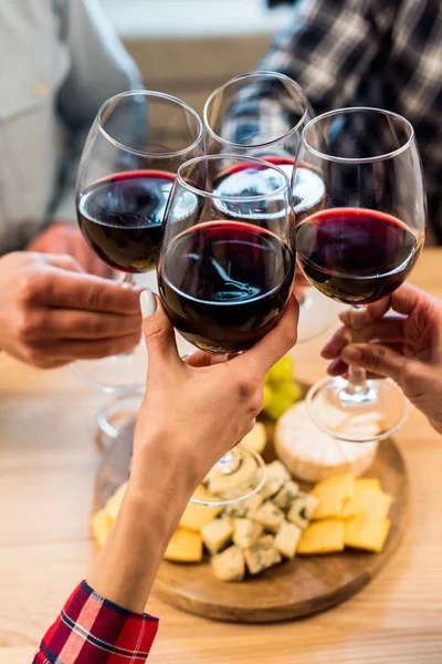 Friends clinking glasses of wine — Stock Photo