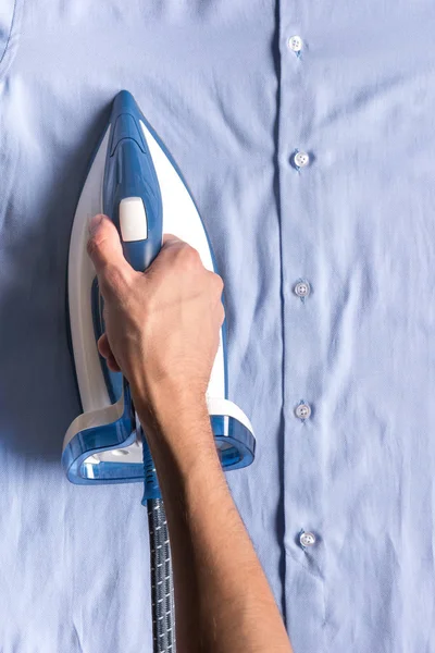 Man ironing shirt — Stock Photo