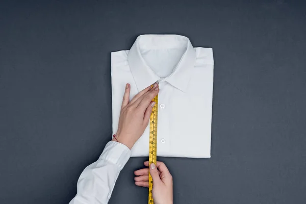 Tailor measuring shirt — Stock Photo