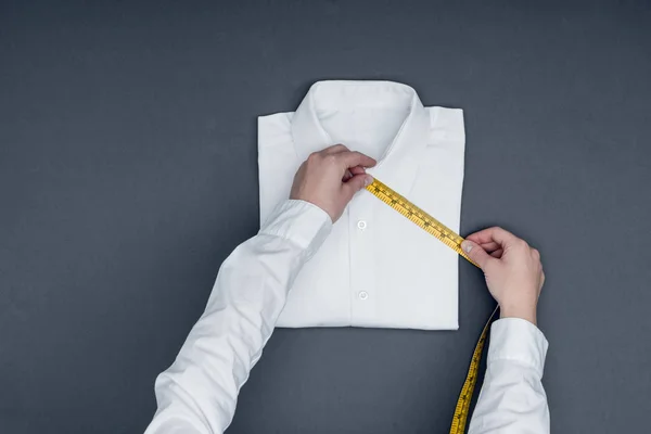 Tailor measuring shirt — Stock Photo