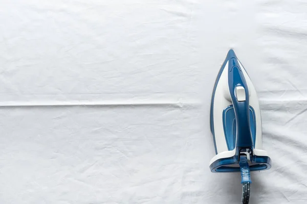 Iron on white sheets — Stock Photo