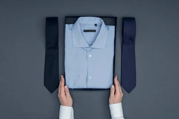 Tailor with shirt in box and neckties — Stock Photo