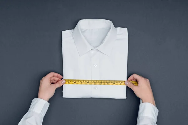 Tailor measuring shirt — Stock Photo