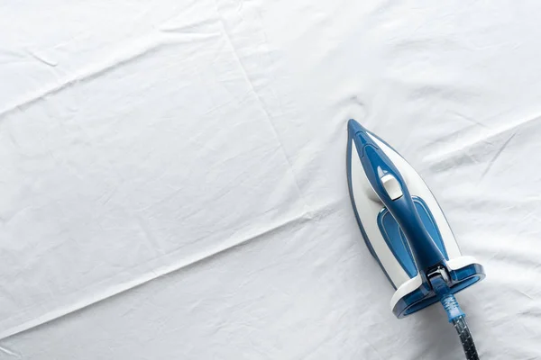 Iron on white sheets — Stock Photo