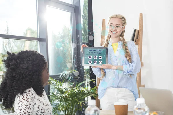 Businesswoman showing tablet to colleague — Stock Photo