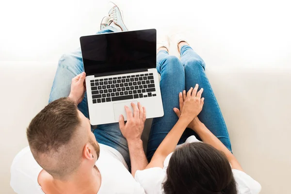 Jeune couple utilisant un ordinateur portable — Photo de stock