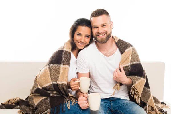 Attractive couple with checkered plaid — Stock Photo