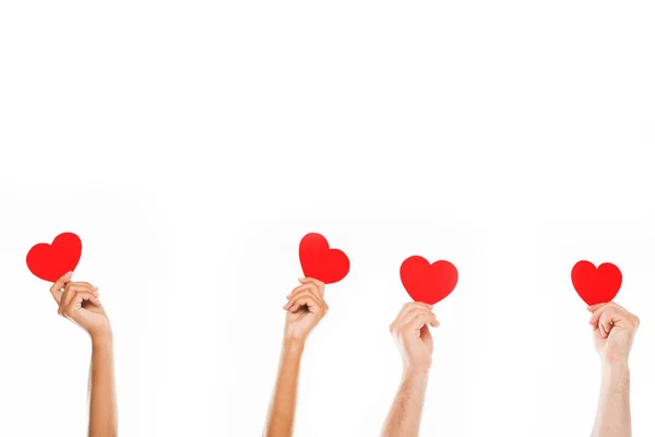 Hands with red paper hearts — Stock Photo