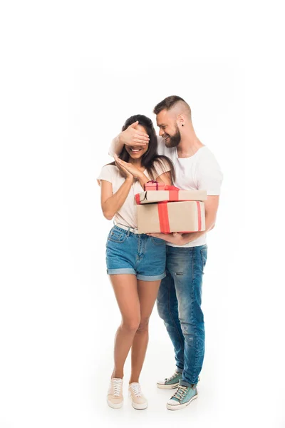 Man surprising girlfriend by gifts — Stock Photo