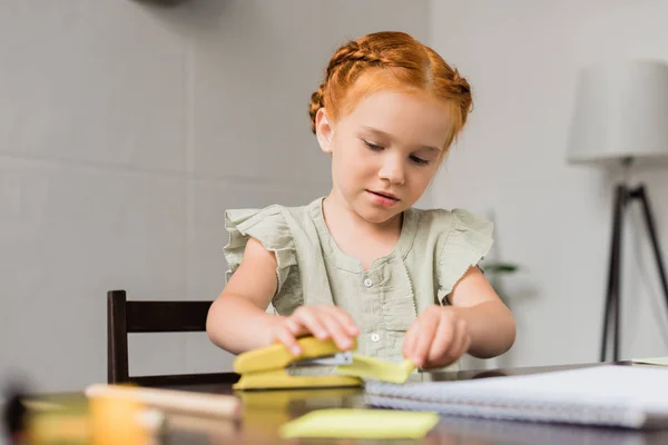 Little girl with stapler — Stock Photo