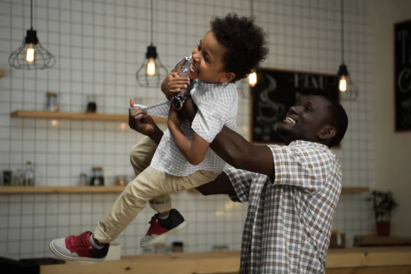 African american father carrying son — Stock Photo