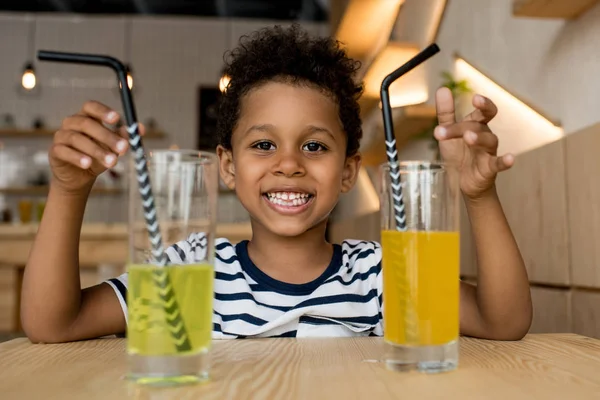 African american child drinking juice — Stock Photo