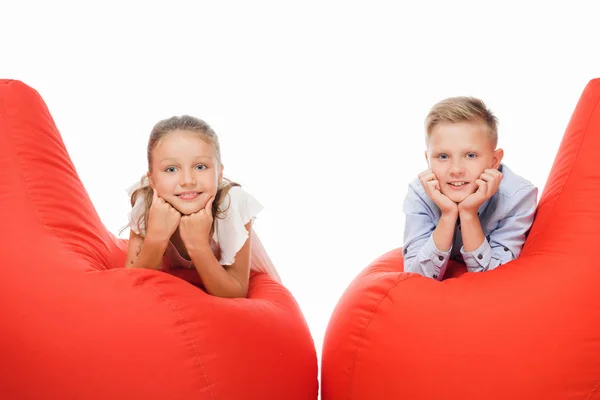 Siblings on bean bag chairs — Stock Photo