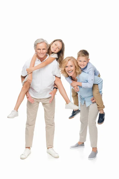 Niños piggybacking en abuelos - foto de stock