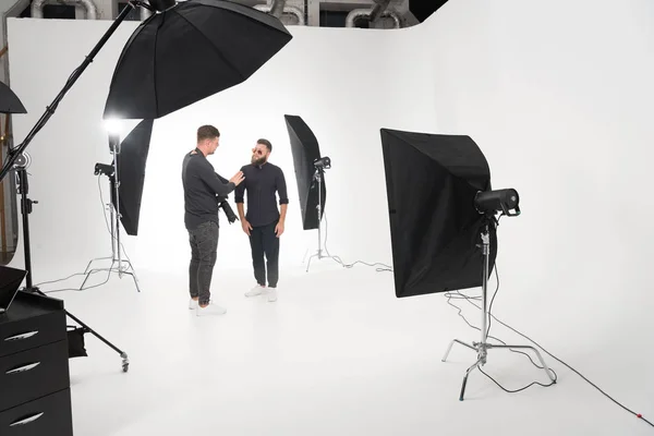 Photographer working in studio with model — Stock Photo