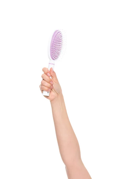 Hand holding hairbrush — Stock Photo