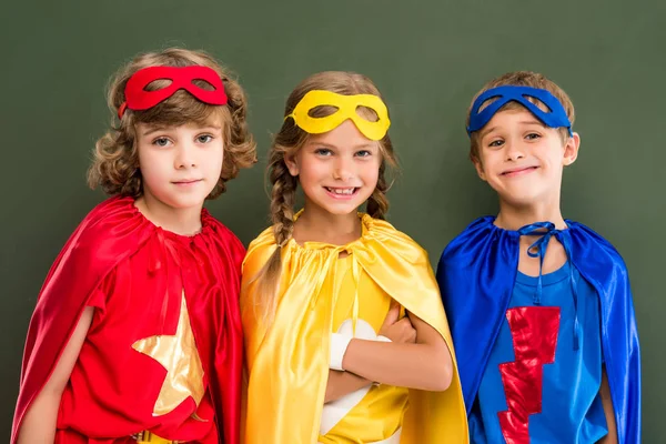 Pupils in superhero costumes — Stock Photo