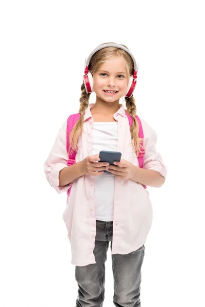 Écolière avec smartphone et écouteurs — Photo de stock