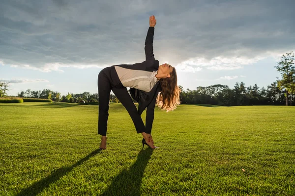 Businesswoman standing in yoga pose — Stock Photo