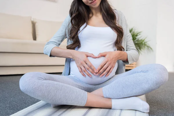 Pregnant woman in lotus pose — Stock Photo