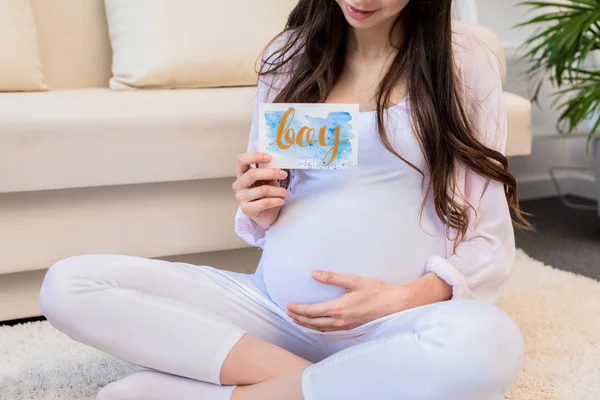 Pregnant woman holding greeting cards — Stock Photo