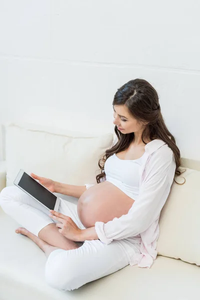 Mujer embarazada con tableta digital - foto de stock
