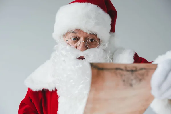 Santa claus with wish list — Stock Photo