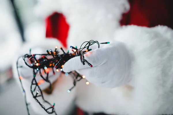 Santa holding festive garland — Stock Photo