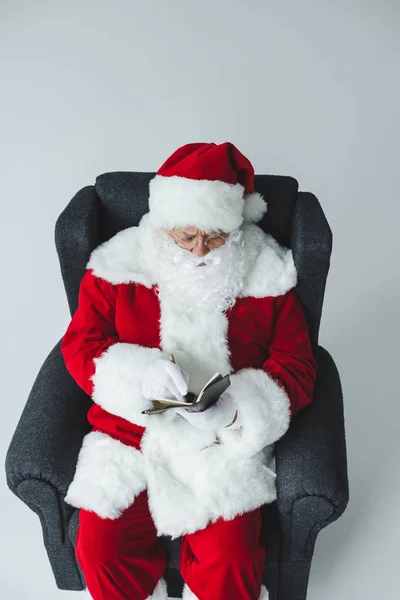 Santa claus writing in notebook — Stock Photo