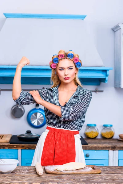 Strong housewife in kitchen — Stock Photo