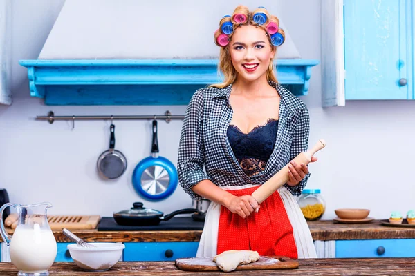 Housewife with dough and rolling pin — Stock Photo
