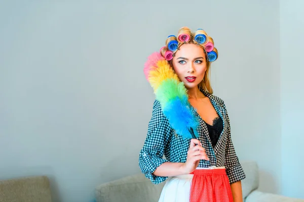 Housewife posing with duster — Stock Photo