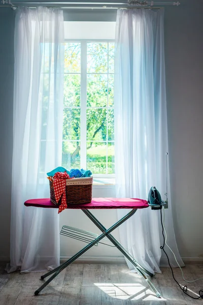 Iron and laundry in basket — Stock Photo