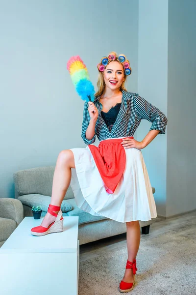 Housewife posing with duster — Stock Photo