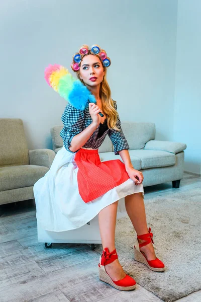 Housewife posing with duster — Stock Photo