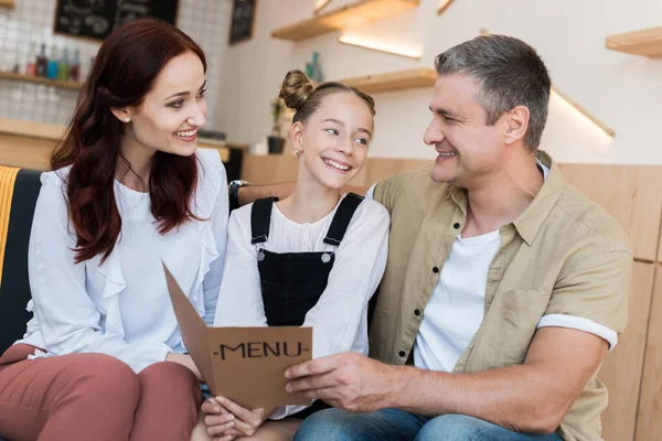 Family looking at menu list in cafe — Stock Photo