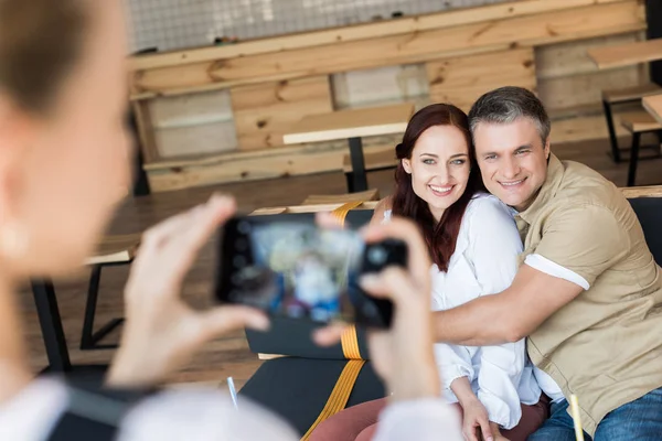 Mature couple embracing in cafe — Stock Photo