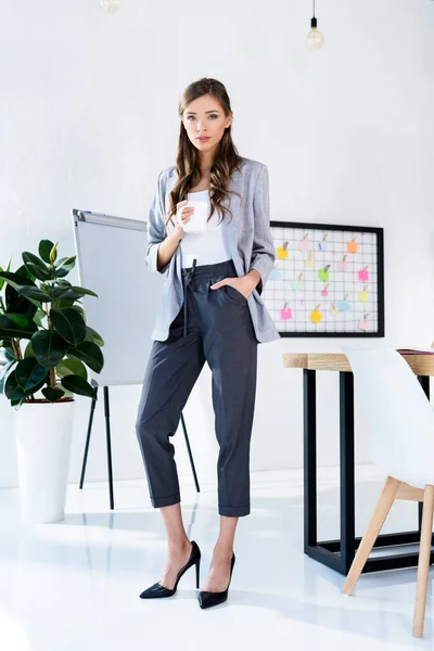 Businesswoman holding cup — Stock Photo