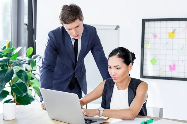 Multiethnic business people working on laptop — Stock Photo