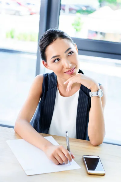 Pensive young businesswoman — Stock Photo
