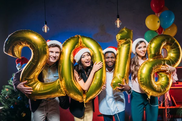 Young friends with golden balloons — Stock Photo