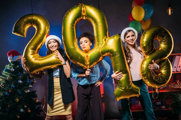 Young friends with golden balloons — Stock Photo
