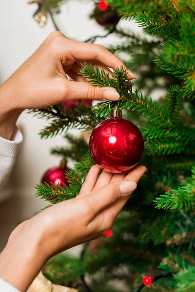 Woman decorating christmas tree — Stock Photo