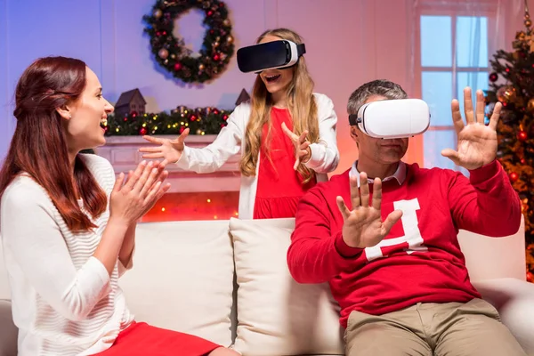 Family in vr goggles on christmas — Stock Photo