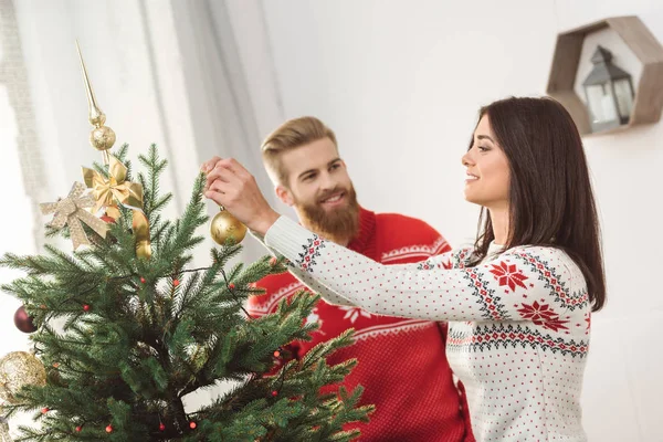 Couple decorating christmas tree — Stock Photo