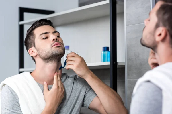 Young man shaving — Stock Photo