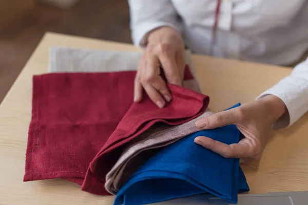 Businesswoman choosing fabric samplers — Stock Photo