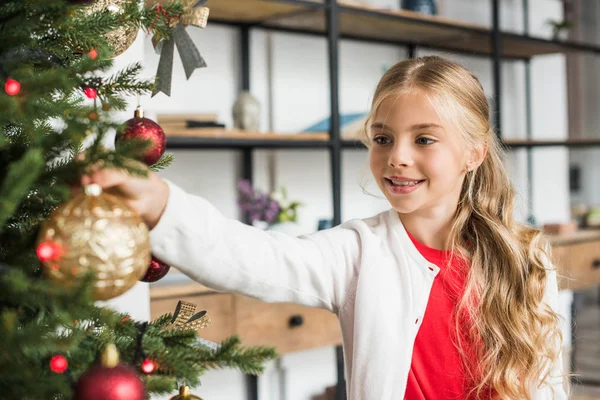 Kid decorating christmas tree — Stock Photo