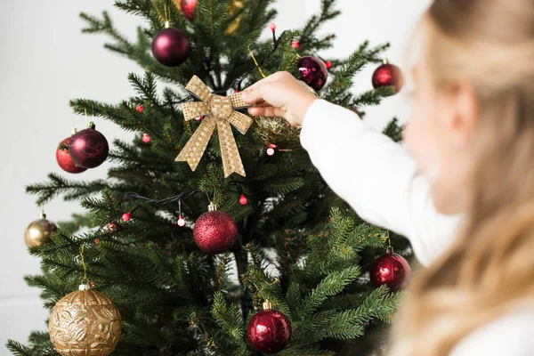 Kid decorating christmas tree — Stock Photo